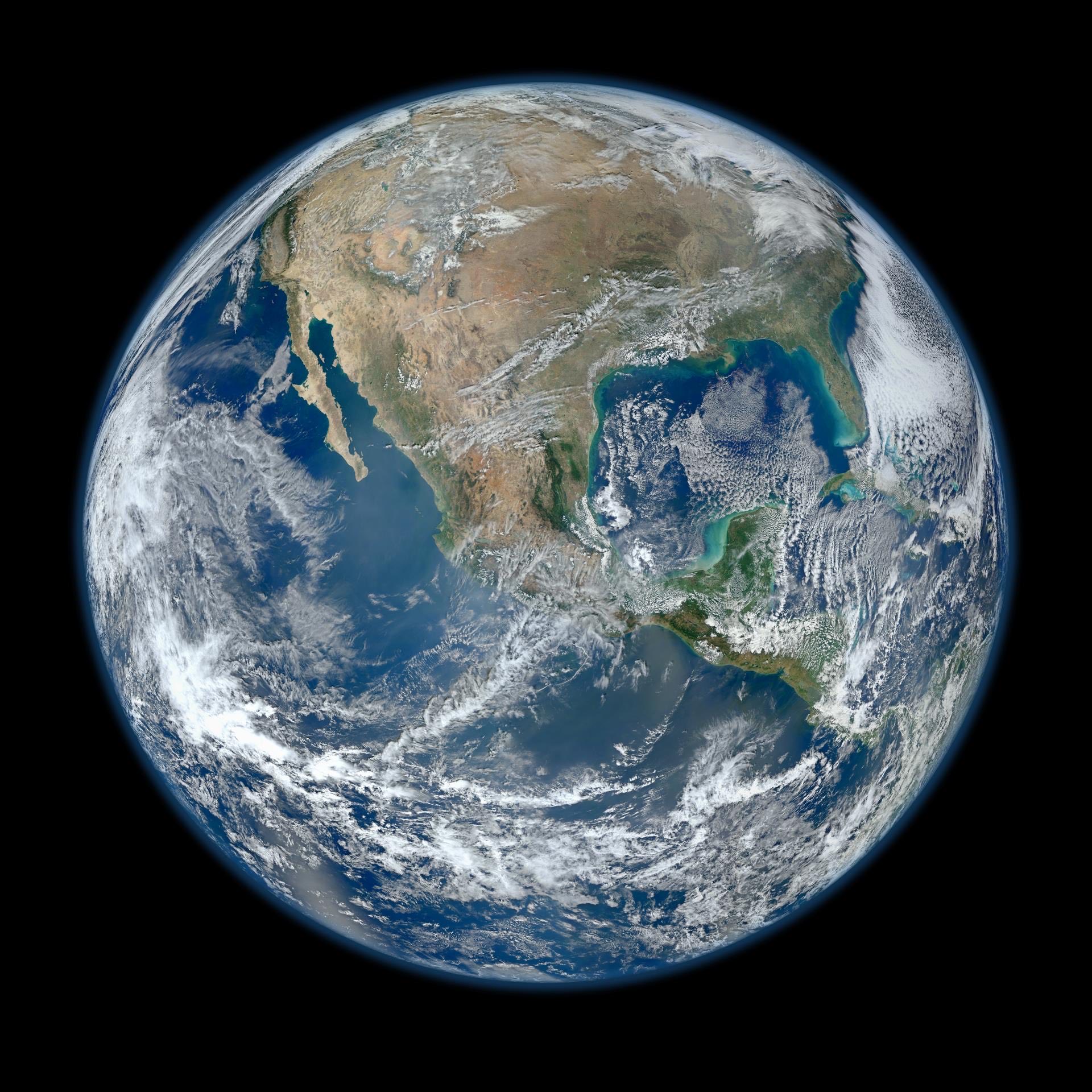 The whole Earth seen from space, cloud systems over ocean and continents.